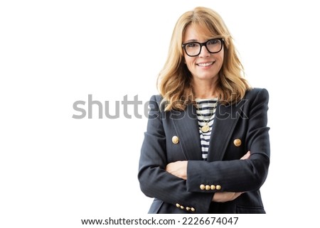 Mature female with arms crossed. Confident businesswoman is against isolated white background. Attractive woman wearing eyewear and blazer. 
