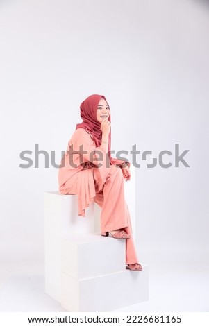 studio portrait of young business woman with hijab fashion on isolated plain background. Corporate people business working concept.