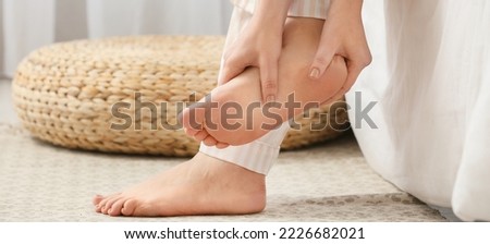 Young woman making foot massage at home, closeup Royalty-Free Stock Photo #2226682021