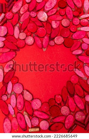 Valentine day with a heart frame and colorful pasta on a red background. Modern conceptual design.