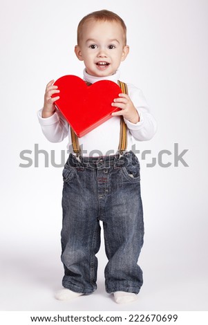 happy boy holds heart in hands