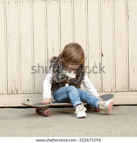 little hipster girl with skateboard portrait