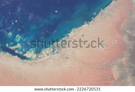 Extension of Persian Gulf coast and red beach seen from space. Elements of this image furnished by NASA