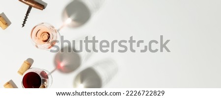 Wine composition with beautiful sunlight and shadows on white background banner