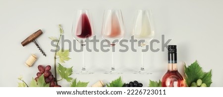 Flat-lay of red, rose and white wine in glasses on white background. Wine bar, winery, wine degustation concept. Minimalistic trendy photography, banner