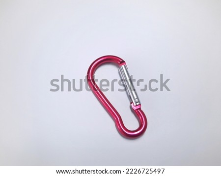 Small carabiner on white background. The carabiner not used for climbing but for hanging accessories or keys. Royalty-Free Stock Photo #2226725497
