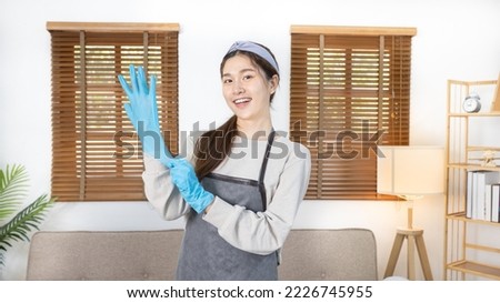 Beautiful Asian housewife wearing apron and cleaning gloves prepares to clean her house, Housework, Daily routine, Big cleaning, Clean and remove germs and dirt in the house, Clean up on weekends. Royalty-Free Stock Photo #2226745955
