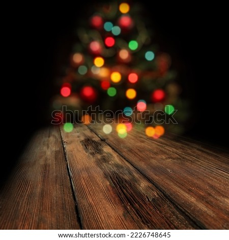 Wooden board of free space for your decoration and dark background with christmas tree lights. 
