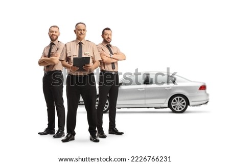 Security officers standing in front of a car isolated on white background