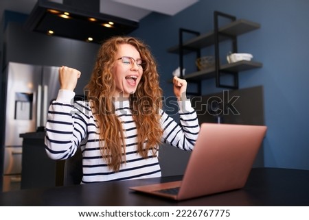 Happy woman checks e-mail, good news about success on laptop. Female rejoice, celebrate visa approval, winning prize and money, project completion confirmation by client, grant approval. Royalty-Free Stock Photo #2226767775