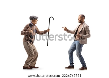 Full length profile shot of an elderly and younger man dancing isolated on white background