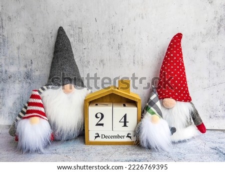 Merry Christmas Greeting Card with Wooden Calendar and Christmas Dwarfs . 24 December  Royalty-Free Stock Photo #2226769395