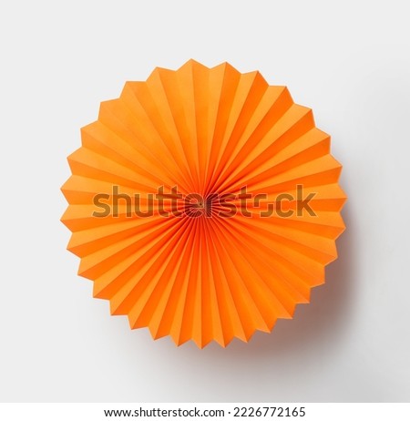 Orange paper fan isolated on white background Royalty-Free Stock Photo #2226772165