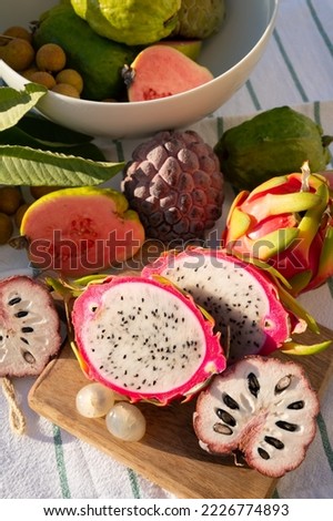 Variaty of tasty tropical exotic fruits, ripe fresh lychee, dragon fruit, guava and cherimoya