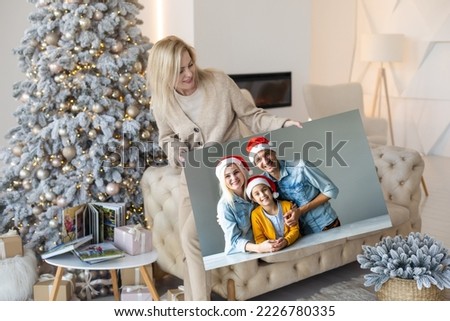 woman holding photo canvas at christmas