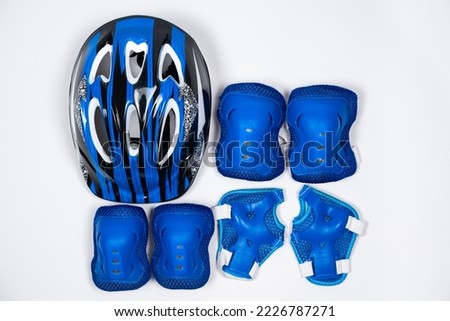 Children's set of protection for cycling, skateboard, roller skates - helmet, knee pads, elbow pads, gloves. Royalty-Free Stock Photo #2226787271