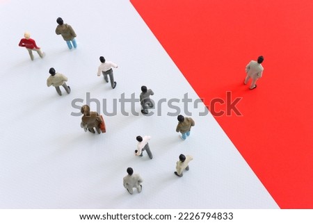 group of people going in one direction and a unique person heading in a different direction.