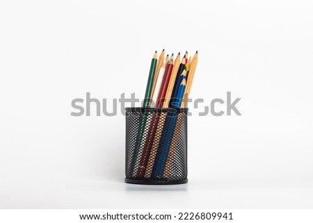 black pen holder full of colored pencils isolated on white background , Education consept idea Royalty-Free Stock Photo #2226809941