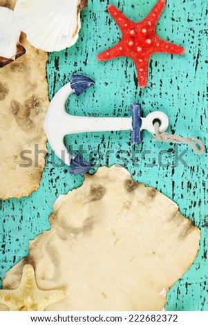 Decor of seashells, starfish and old paper on  color wooden background