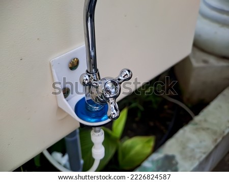 water faucet made of metal in a public park