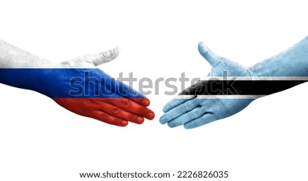 Handshake between Botswana and Russia flags painted on hands, isolated transparent image.