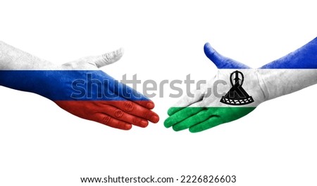 Handshake between Lesotho and Russia flags painted on hands, isolated transparent image.
