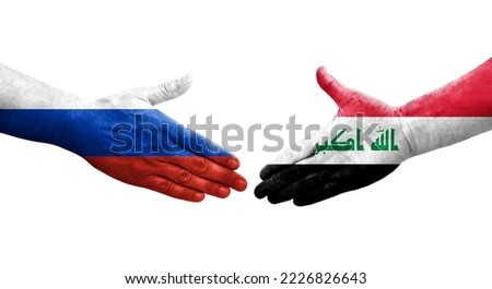 Handshake between Iraq and Russia flags painted on hands, isolated transparent image.