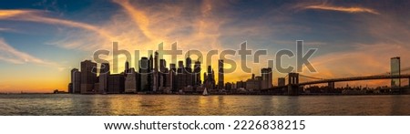 Panorama of  Brooklyn Bridge and panoramic night view of downtown Manhattan at sunset in New York City, USA