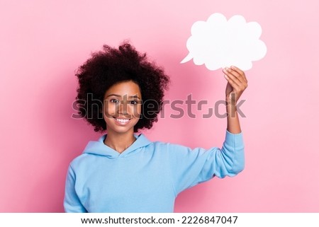 Photo portrait of adorable school girl hold white cloud speech comics bubble dressed stylish blue look isolated on pink color background