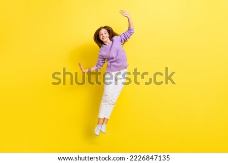 Full length photo of overjoyed lady wear violet comfort clothes raise hand cool party holiday weekend isolated on yellow color background