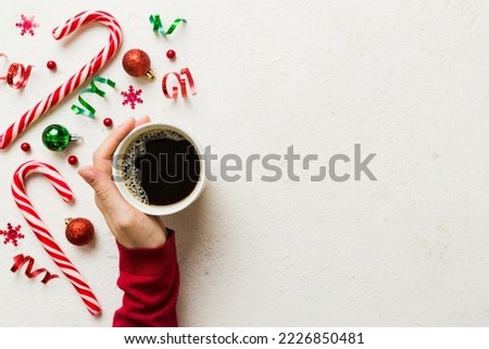 Woman holding cup of coffee. Woman hands holding a mug with hot coffee. Winter and Christmas time concept.