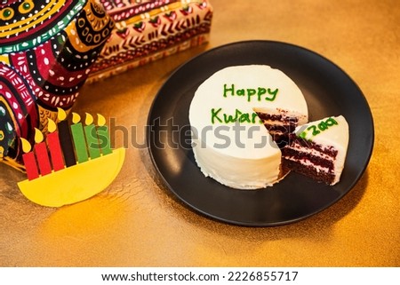 Happy Kwanzaa bento cake and gifts in boxes wrapped in hand-painted paper