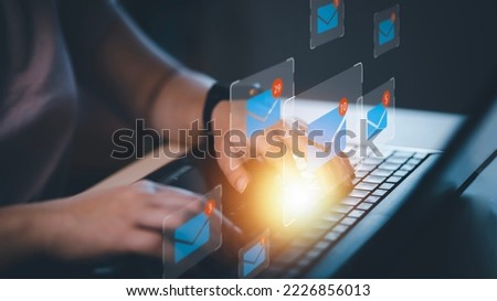 Businesswoman holding smartphone with communication icons, letter icon, email icons, and newsletter email and protect your personal information or spam mail, Customer service call center contact.