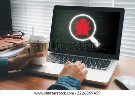 Software development and debugging concept, Person hand using laptop computer with bug software icon on screen, Software security, Computer bug, failure or error of software.