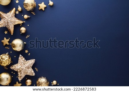 Luxury gold Christmas decorations on dark blue background. Xmas greeting card template, Happy New Year banner mockup. Royalty-Free Stock Photo #2226872583