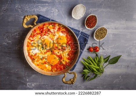 Famous Turkish menemen dinner on table, made by eggs, pepper and tomatoes. Royalty-Free Stock Photo #2226882287