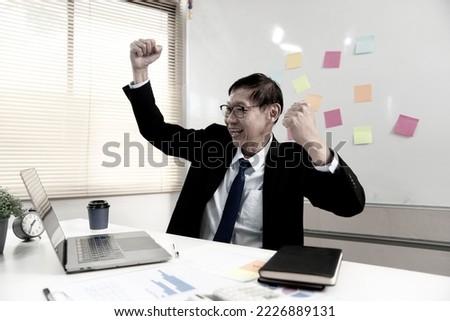 businessman executive or manager Delighted to show signs of success  cheers in the office with notes on the board.