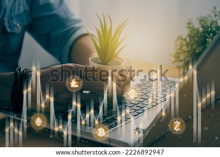 Casual Businessman Hand Hold Office Plants with Cryptocurrency Sign Icon, Stock Bar Chart and Line Graph. Business Growth and Financial Stock Market Concept in Vintage Tone