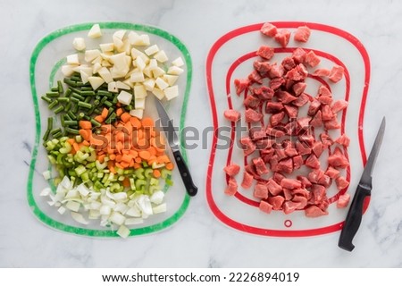 Chopped beef stew ingredients on different mats to prevent cross contamination. Royalty-Free Stock Photo #2226894019