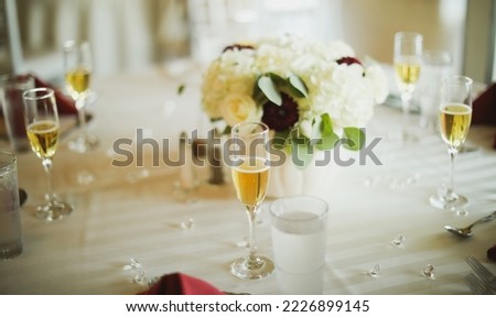 alcohol at party dinner table during wedding ceremony with flowers 