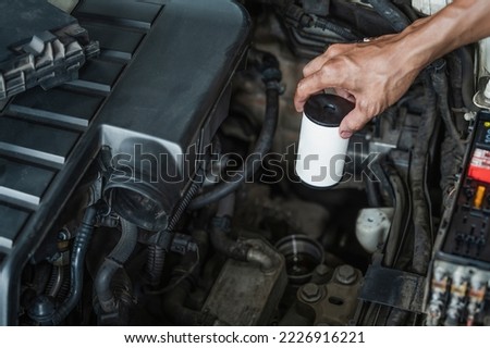 Auto mechanic replacing DSG transmission oil filler. Royalty-Free Stock Photo #2226916221