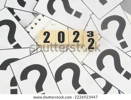 Numbers 2022 and 2023 on calendar and many question marks. FAQ about new year 2023.