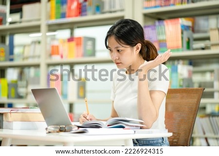 beautiful asian girl studying in the library