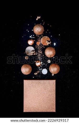 Christmas tree made of golden box, Christmas decor, sparkles on black background