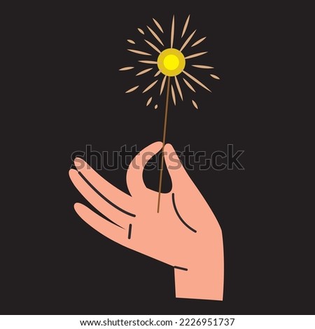 hand with sparkler on black background
