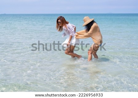 Beautiful girl friendship happy enjoy laughing and play on the blue sea and white sand beach
