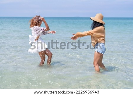 Beautiful girl friendship happy enjoy laughing and play on the blue sea and white sand beach