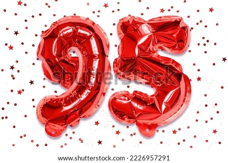 The number of the balloon made of red foil, the number ninety five on a white background with sequins. Birthday greeting card with inscription 95. Anniversary concept. Royalty-Free Stock Photo #2226957291