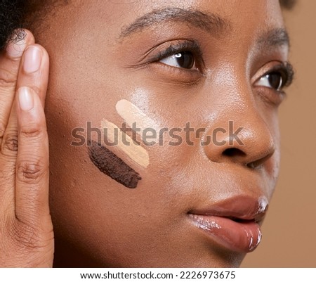 Beauty, makeup and foundation shades on face of black woman with swatch for cosmetics, diversity or base tone. Visage, product and glamour with different color on girl model for concealer or textures Royalty-Free Stock Photo #2226973675