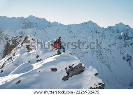 Tourist with a backpack and mountain panorama. Mountains with mount Everest, Earth's highest mountain. Travel sport lifestyle concept Royalty-Free Stock Photo #2226982495